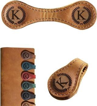 Stylish leather bag tags with monograms in an elegant wooden box, perfect for personalized travel accessories.